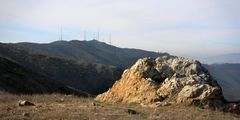 Large rock and mountains with electricity antenna