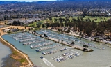 Aerial view of Coyote Point Marina with boats lined up in dock and park in background