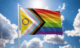Intersex Inclusive Progress Pride flag on flagpole with sky behind
